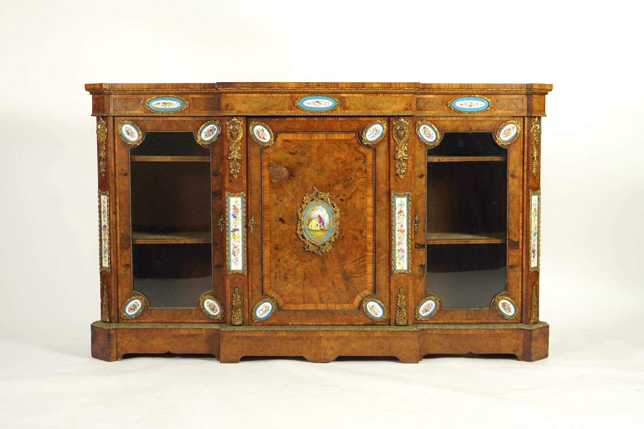 A Victorian tulip banded and gilt metal mounted walnut breakfront side cabinet